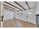 Bright, spacious living area with wood floors, beamed ceiling, and ample natural light at 1616 Huntington St, Lakeland, FL 33801