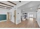 Spacious living room featuring wood floors and wooden ceiling beams, leading to a well-appointed kitchen at 1616 Huntington St, Lakeland, FL 33801
