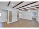 Open-concept space with beamed ceilings, wood floors, and custom-built storage at 1616 Huntington St, Lakeland, FL 33801