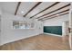 Light-filled open concept area with sleek lighting, an accent wall and stylish wood floors at 1616 Huntington St, Lakeland, FL 33801