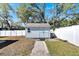 Close up of the outdoor shed featuring doors, a window, and landscaping at 1616 Huntington St, Lakeland, FL 33801