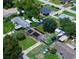 Aerial view of a home with mature trees, sheds, and a fenced in backyard at 1841 Talmadge St, Deland, FL 32724