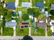 Aerial view of a home surrounded by a fenced yard with mature trees in a quiet residential neighborhood at 1841 Talmadge St, Deland, FL 32724