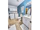 Bathroom featuring blue walls, a laundry, and coordinating decor at 1841 Talmadge St, Deland, FL 32724