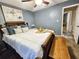 Comfortable bedroom with queen bed, blanket, artwork, blinds, and light-filtering curtains at 1841 Talmadge St, Deland, FL 32724