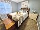 Comfortable bedroom with bed, blanket, artwork, blinds, and light-filtering curtains at 1841 Talmadge St, Deland, FL 32724