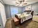 Comfortable bedroom with queen bed, blanket, artwork, blinds, and light-filtering curtains at 1841 Talmadge St, Deland, FL 32724