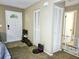 Inviting entryway with white door, tile transitioning to carpet, and closet space at 1841 Talmadge St, Deland, FL 32724