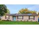 Charming single-story home featuring a welcoming blue door and modern solar panels on the roof at 1841 Talmadge St, Deland, FL 32724