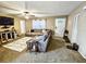 Cozy living room with a large sectional sofa and neutral carpet, bathed in natural light from the front door at 1841 Talmadge St, Deland, FL 32724