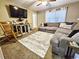Comfortable living room featuring a sectional sofa, stylish rug, rocking chair, and wall-mounted TV for relaxed living at 1841 Talmadge St, Deland, FL 32724