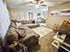 Inviting living room with a large sectional, neutral rug, and an open layout connecting to the dining area at 1841 Talmadge St, Deland, FL 32724