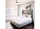 Tastefully designed bedroom with a large bed and neutral color palette, hardwood floors at 2864 Running Brook Cir, Kissimmee, FL 34744