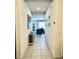 Hallway leads to a welcoming living area with natural light and neutral tones at 2864 Running Brook Cir, Kissimmee, FL 34744