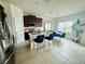Bright kitchen with stainless steel appliances, island seating, and adjacent dining area at 2864 Running Brook Cir, Kissimmee, FL 34744