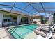 Open-air view of screened-in pool, furnished patio, ceiling fans and brick pavers in the backyard at 3249 Pearly Dr, Lakeland, FL 33812
