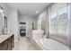 Bright bathroom featuring a walk-in shower, soaking tub, and dual vanities at 3249 Pearly Dr, Lakeland, FL 33812