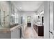 Elegant bathroom featuring a glass shower, soaking tub, and dual vanities with granite countertops at 3249 Pearly Dr, Lakeland, FL 33812
