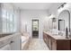 Elegant bathroom featuring a glass shower, soaking tub, and dual vanities with granite countertops at 3249 Pearly Dr, Lakeland, FL 33812