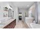 Bright bathroom featuring a walk-in shower, soaking tub, and dual vanities at 3249 Pearly Dr, Lakeland, FL 33812