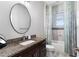 Bathroom featuring a granite vanity, an oval mirror, and a shower with decorative curtain and tile at 3249 Pearly Dr, Lakeland, FL 33812