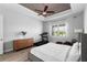 Bright bedroom with a tray ceiling, a ceiling fan, wood-style flooring, and a large window at 3249 Pearly Dr, Lakeland, FL 33812