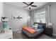Bright bedroom features a queen-sized bed, ceiling fan, large window, and dedicated workspace with desk and chair at 3249 Pearly Dr, Lakeland, FL 33812