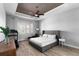 Spacious primary bedroom features a tray ceiling, ceiling fan and a large window at 3249 Pearly Dr, Lakeland, FL 33812