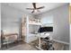Comfortable bedroom featuring a bunk bed, ceiling fan, and desk with a monitor at 3249 Pearly Dr, Lakeland, FL 33812