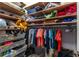 A fully stocked closet with wooden shelves, wire baskets, and rods filled with neatly organized items at 3249 Pearly Dr, Lakeland, FL 33812
