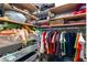 A fully stocked closet with wooden shelves, wire baskets, and rods filled with neatly organized items at 3249 Pearly Dr, Lakeland, FL 33812