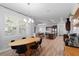 Open-concept dining area features wood-look floors, a modern chandelier, and flows into the kitchen and living area at 3249 Pearly Dr, Lakeland, FL 33812