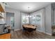 Bright dining area boasts natural light from the windows, stylish light fixture, and wood-look floors at 3249 Pearly Dr, Lakeland, FL 33812