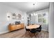 Bright dining area features a modern buffet, open shelving, stylish lighting, and wood-look floors at 3249 Pearly Dr, Lakeland, FL 33812
