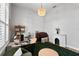 Bright home office featuring hardwood floors, modern desk and a decorative fireplace at 3249 Pearly Dr, Lakeland, FL 33812