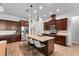 Spacious kitchen features a large island, granite countertops, dark wood cabinets, and stainless steel appliances at 3249 Pearly Dr, Lakeland, FL 33812