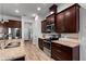 Modern kitchen with granite countertops, stainless steel appliances, dark wood cabinets, and wood-look flooring at 3249 Pearly Dr, Lakeland, FL 33812