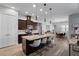 Beautiful kitchen with an island, granite countertops, stainless steel appliances, wood look floors, and stylish pendant lights at 3249 Pearly Dr, Lakeland, FL 33812