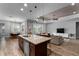 Open kitchen with granite countertops, stainless appliances, breakfast bar, open to living room at 3249 Pearly Dr, Lakeland, FL 33812