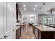 Modern kitchen features dark wood cabinetry, granite countertops, stainless steel appliances, and an island with pendant lighting at 3249 Pearly Dr, Lakeland, FL 33812