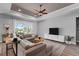 Comfortable living room with large sectional sofa and a view of the screened in patio and landscaping at 3249 Pearly Dr, Lakeland, FL 33812