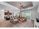 Spacious living room with a large sectional sofa, open to the modern kitchen, and golf course views at 3249 Pearly Dr, Lakeland, FL 33812