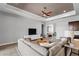 Open-concept living room features a large sectional sofa, modern decor, and seamless flow at 3249 Pearly Dr, Lakeland, FL 33812