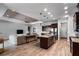 Spacious living area with a tray ceiling, recessed lighting, flows into the kitchen, and features wood-look floors at 3249 Pearly Dr, Lakeland, FL 33812
