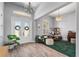 Inviting home office features ample natural light, decorative wreaths on the glass doors, and wood-look floors at 3249 Pearly Dr, Lakeland, FL 33812