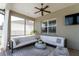 Comfortable, furnished, screened-in patio with a ceiling fan and neutral-colored decor, perfect for relaxing at 3249 Pearly Dr, Lakeland, FL 33812