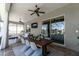 Comfortable, furnished, screened-in patio featuring an outdoor lounge area and dining area with ceiling fans at 3249 Pearly Dr, Lakeland, FL 33812