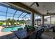 Comfortable, furnished, screened-in patio with a dining area overlooking the pool and backyard at 3249 Pearly Dr, Lakeland, FL 33812