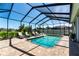 Screened-in pool with surrounding brick pavers and comfortable lounge furniture, perfect for outdoor living at 3249 Pearly Dr, Lakeland, FL 33812