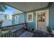 Relaxing back porch with wooden bench, potted plants and a door to the home at 549 Palencia Pl, Lakeland, FL 33803